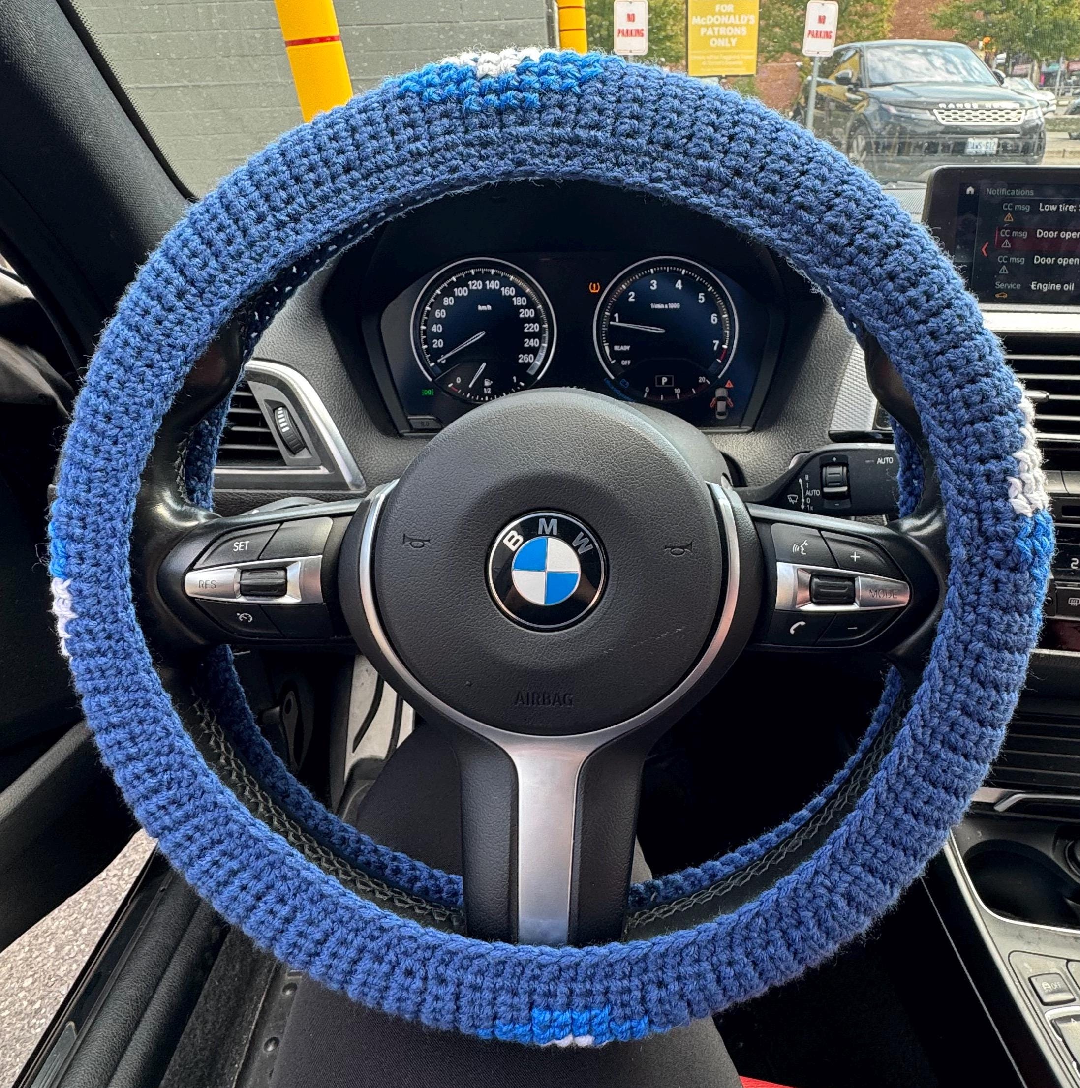 Crochet steering wheel cover.
