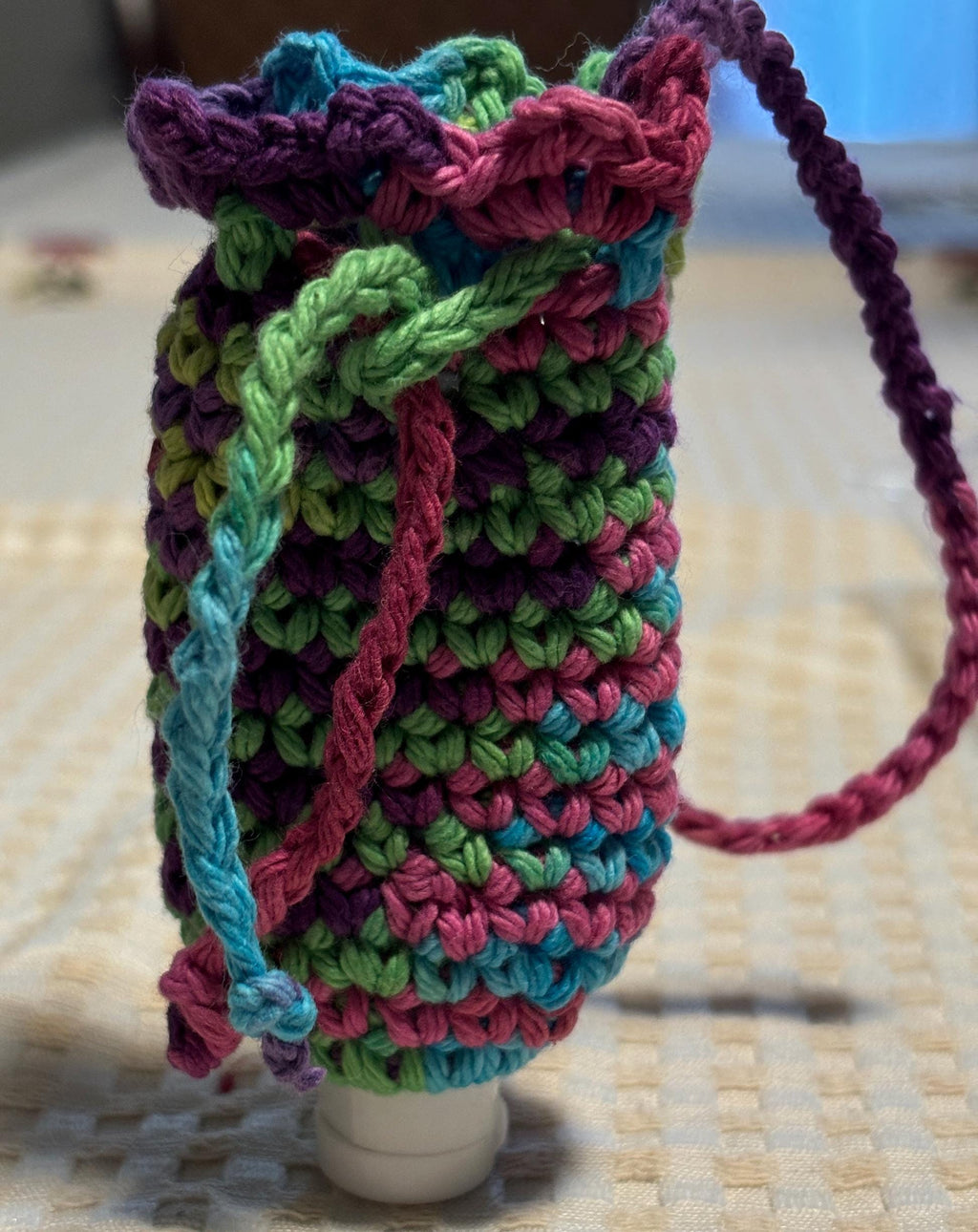 Rainbow crochet coin purse and hand sanitizer holder set.