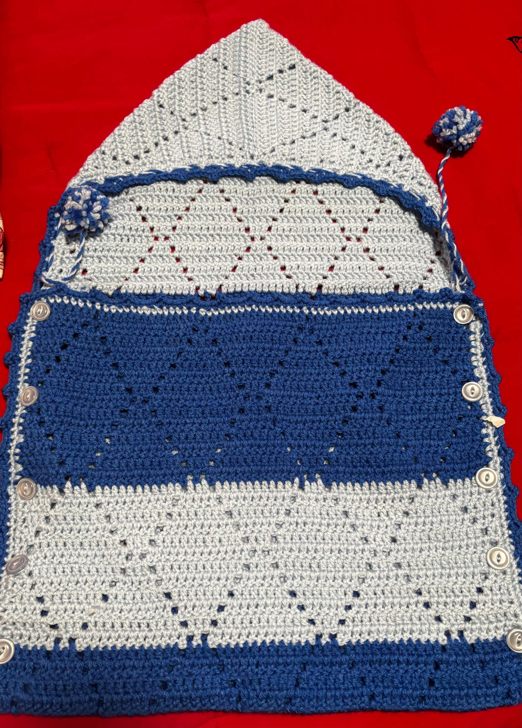 Crochet baby hooded envelope blanket.