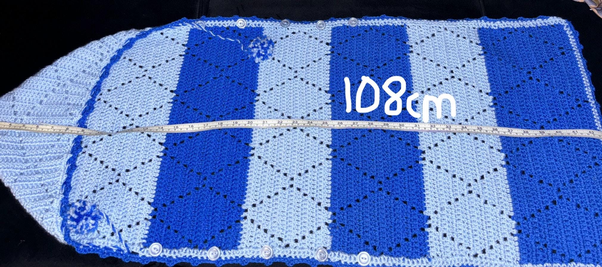 Crochet baby hooded envelope blanket.