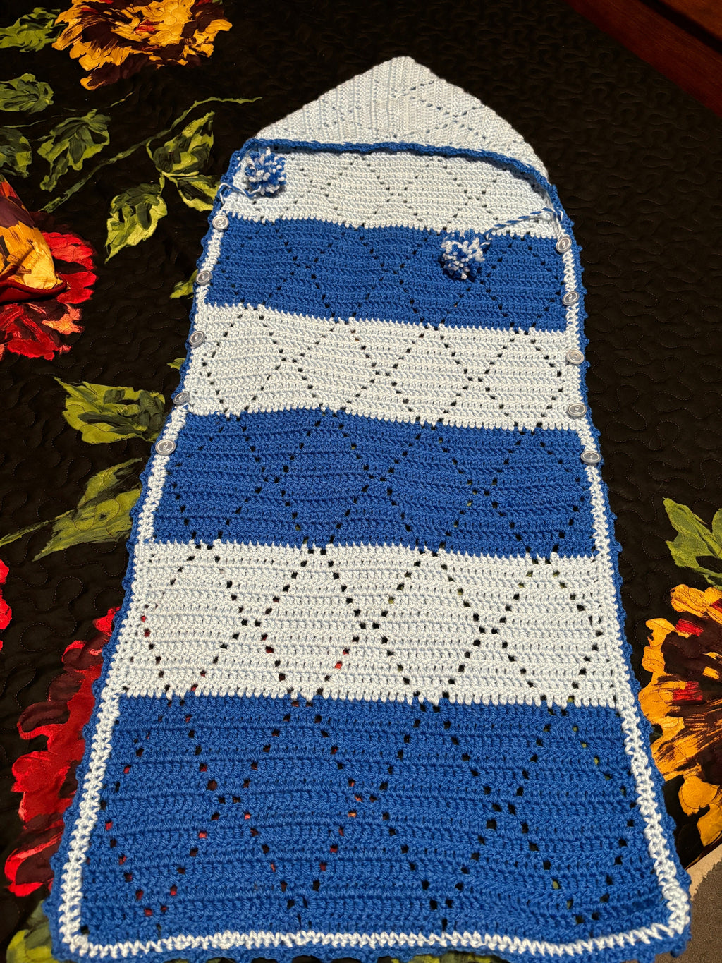 Crochet baby hooded envelope blanket.
