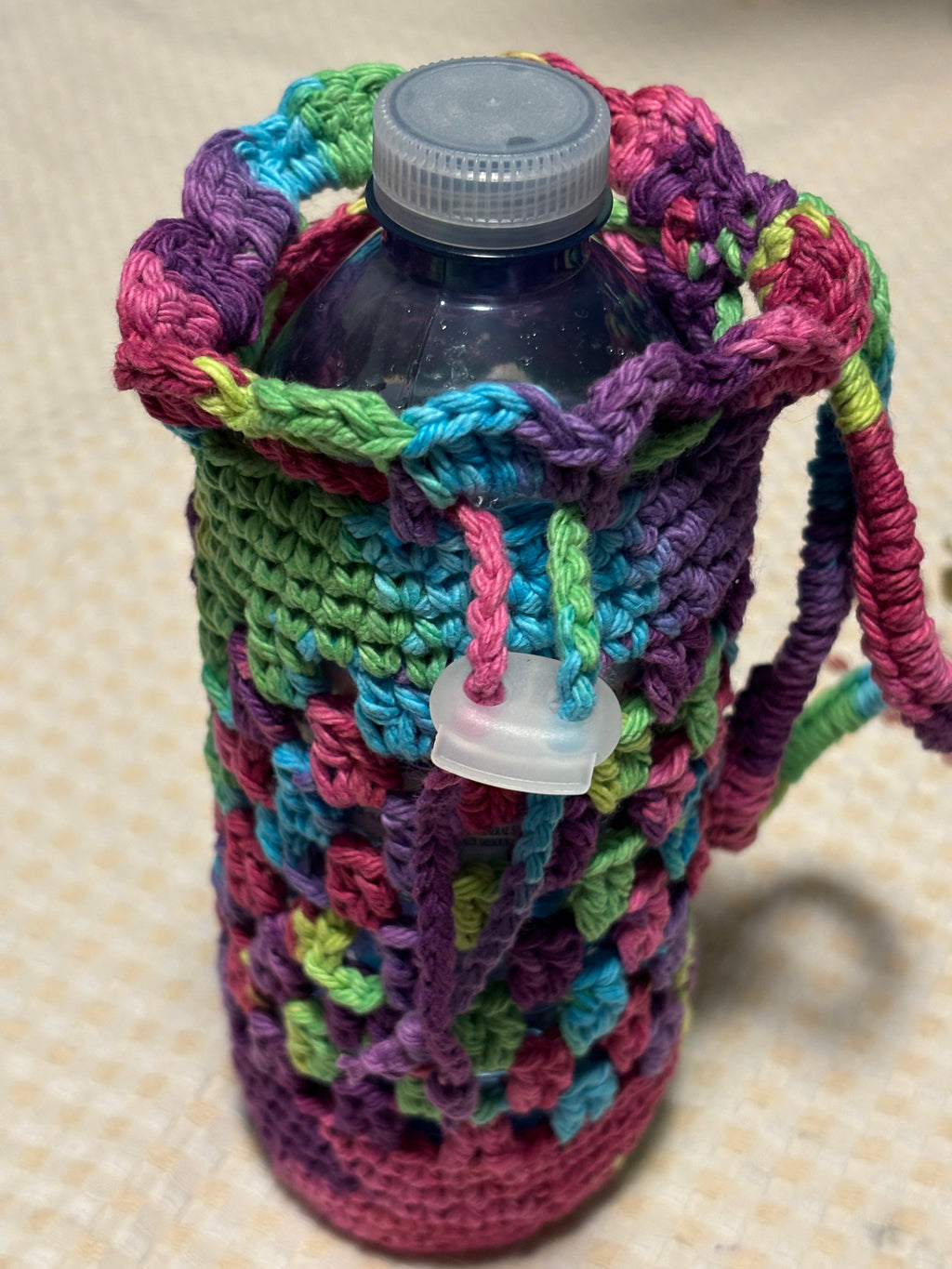 Rainbow crochet water bottle holder.