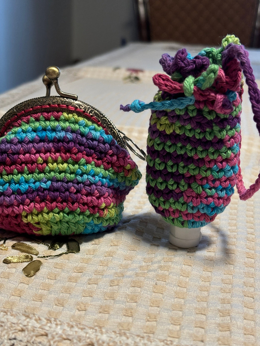 Rainbow crochet coin purse and hand sanitizer holder set.